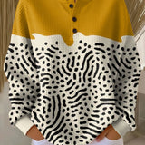 Leona – Moderan pulover s kontrastnim žuto-crnim apstraktnim uzorkom